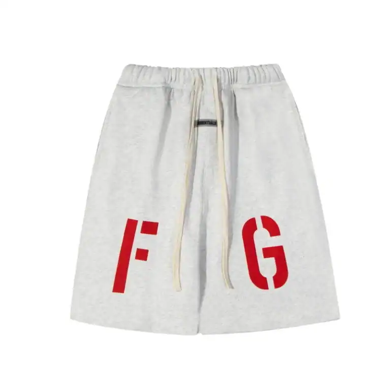 Soft heather gray Fear of God Essentials shorts with bold red lettering and a comfortable drawstring waistband, perfect for casual and athleisure style.